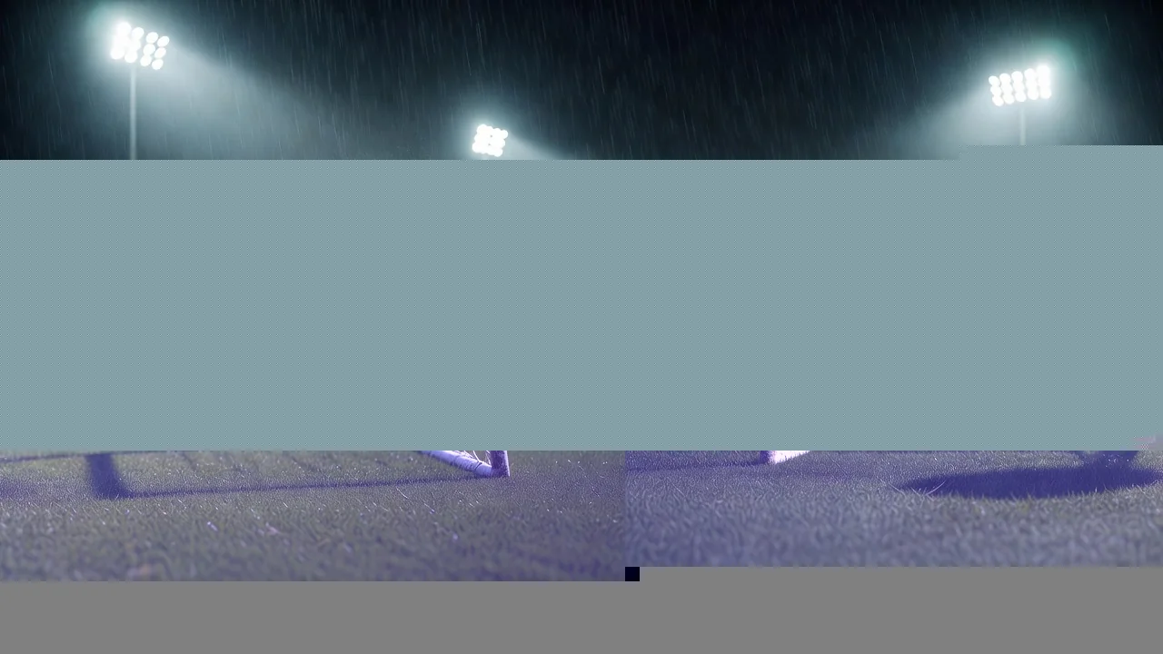Football resting in the back of a goal net